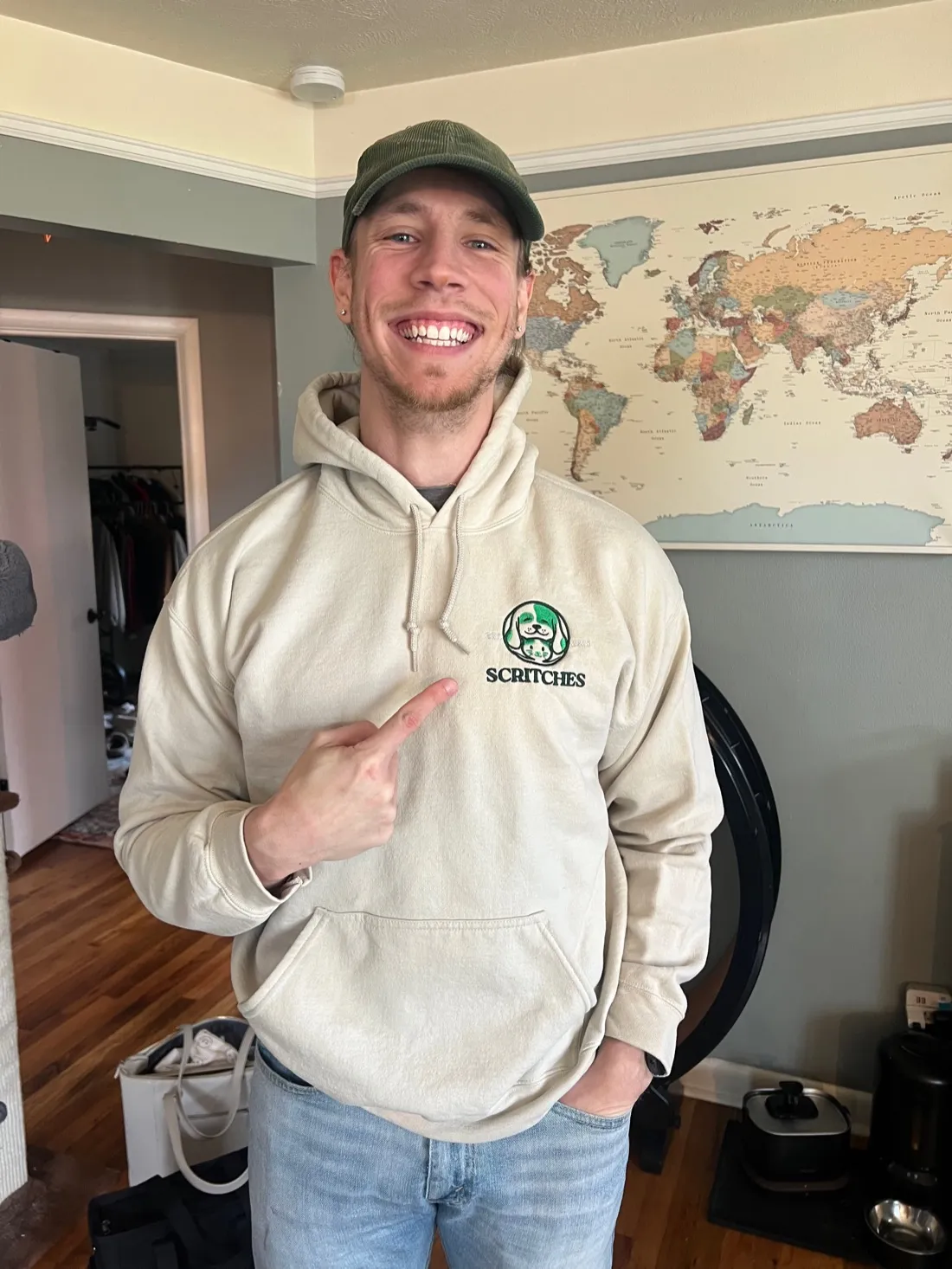 Lucas happily pointing at the Scritches logo on his sweatshirt